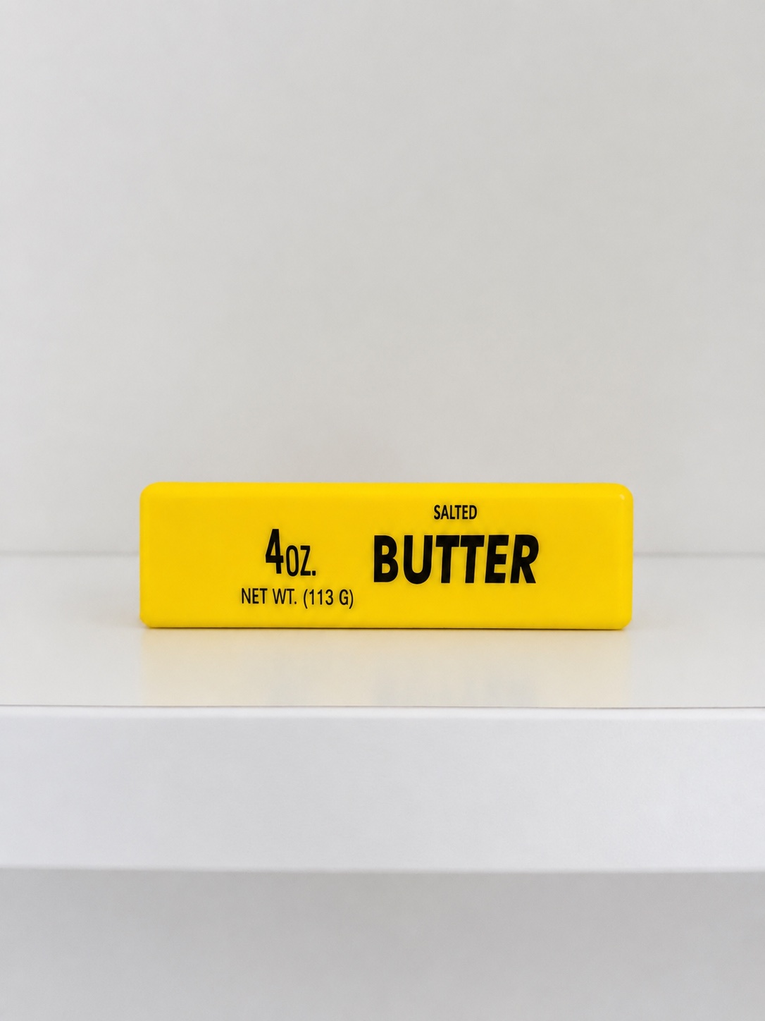 Front view of the Small Butter Squishy with black lettering